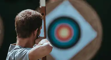 men is targeting a target with a bow and arrow symbol of the perfect way pure for life's canabidiol products are finding the pain and relieving it
